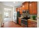 Well-appointed kitchen with stainless steel appliances and view into the dining area at 9618 Springholm Dr, Charlotte, NC 28278