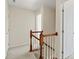 Upstairs hall features a hardwood and white painted staircase with neutral carpet and trim at 9618 Springholm Dr, Charlotte, NC 28278