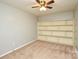 Bedroom featuring built-in shelving, ceiling fan, and neutral walls at 10805 Winterbourne Ct, Charlotte, NC 28277