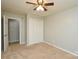 Cozy bedroom with neutral carpet, a ceiling fan, and lots of closet space at 10805 Winterbourne Ct, Charlotte, NC 28277