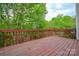 Spacious wooden deck overlooking lush greenery, perfect for outdoor relaxation at 10805 Winterbourne Ct, Charlotte, NC 28277