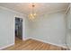 Elegant dining room with modern light fixture and access to the kitchen at 10805 Winterbourne Ct, Charlotte, NC 28277