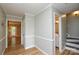 Inviting hallway with beautiful wood floors, crown molding, and access to bath and stairs at 10805 Winterbourne Ct, Charlotte, NC 28277