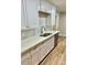 Well-lit kitchen featuring stainless steel appliances, white cabinets, and countertops with an eat-in area at 10805 Winterbourne Ct, Charlotte, NC 28277