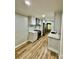 Bright kitchen with stainless steel appliances, white cabinets, countertops, and hardwood floors at 10805 Winterbourne Ct, Charlotte, NC 28277
