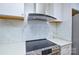 Modern kitchen with sleek stainless steel appliances and stylish marble backsplash at 10805 Winterbourne Ct, Charlotte, NC 28277