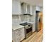 Modern kitchen features stainless steel appliances, updated cabinetry, and stylish marble backsplash at 10805 Winterbourne Ct, Charlotte, NC 28277