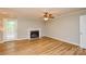 Open-concept living room with fireplace, ceiling fan and lots of natural light at 10805 Winterbourne Ct, Charlotte, NC 28277