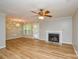 Bright living room featuring a fireplace, ceiling fan, and access to outdoor deck at 10805 Winterbourne Ct, Charlotte, NC 28277