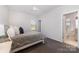 This secondary bedroom features carpet, a ceiling fan, and attached bathroom at 109 Crossvine Dr, Mooresville, NC 28117