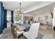 Spacious dining room with a long wooden table, stylish chairs, and a modern chandelier at 109 Crossvine Dr, Mooresville, NC 28117