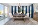 Elegant dining room featuring a large wooden table, comfortable seating, and natural light at 109 Crossvine Dr, Mooresville, NC 28117