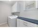 This laundry room features a front-load washer and dryer, plus built-in storage at 109 Crossvine Dr, Mooresville, NC 28117