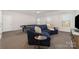 Comfortable living room features a sectional sofa and pool table in the background at 109 Crossvine Dr, Mooresville, NC 28117