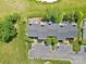 Aerial shot of townhome rooftops featuring back patio with seating areas and nearby parking at 10942 Winterbourne Ct, Charlotte, NC 28277