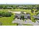 Scenic aerial view of townhomes overlooking a lush golf course and tranquil pond, showcasing community charm at 10942 Winterbourne Ct, Charlotte, NC 28277