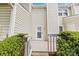 Back porch with access to the yard surrounded by green hedges and bushes at 10942 Winterbourne Ct, Charlotte, NC 28277