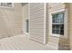 Neutral tone back porch in a private setting with two windows at 10942 Winterbourne Ct, Charlotte, NC 28277
