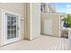 A back porch area that has a door to the left and an access door to the right at 10942 Winterbourne Ct, Charlotte, NC 28277