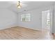 Spacious bedroom featuring wood floors, a ceiling light, and a view of closet space at 10942 Winterbourne Ct, Charlotte, NC 28277