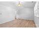 Well-lit bedroom with wood floors, white walls, and open closet access at 10942 Winterbourne Ct, Charlotte, NC 28277