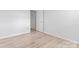 Well-lit bedroom with light wood flooring and door access at 10942 Winterbourne Ct, Charlotte, NC 28277