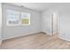 Cozy bedroom with ample natural light from the window, and light wood flooring at 10942 Winterbourne Ct, Charlotte, NC 28277