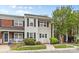 Charming two-story townhome with light siding, dark shutters and green landscaping at 10942 Winterbourne Ct, Charlotte, NC 28277