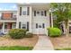 Charming two-story townhome with light siding, dark shutters and green landscaping at 10942 Winterbourne Ct, Charlotte, NC 28277