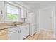 Bright kitchen featuring white cabinets, granite countertops, and stainless steel appliances at 10942 Winterbourne Ct, Charlotte, NC 28277