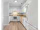 Bright kitchen featuring white cabinets, granite countertops, and stainless steel appliances at 10942 Winterbourne Ct, Charlotte, NC 28277