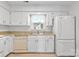 Bright kitchen featuring white cabinets, granite countertops, and stainless steel appliances at 10942 Winterbourne Ct, Charlotte, NC 28277