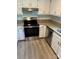 Bright kitchen features stainless steel appliances, granite countertops, and white cabinets at 10942 Winterbourne Ct, Charlotte, NC 28277