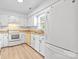 Bright kitchen featuring white cabinets, granite countertops, and stainless steel appliances at 10942 Winterbourne Ct, Charlotte, NC 28277