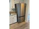 Updated kitchen features stainless steel refrigerator and white cabinets at 10942 Winterbourne Ct, Charlotte, NC 28277