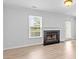 Bright living room with fireplace, large window and door leading to the outside at 10942 Winterbourne Ct, Charlotte, NC 28277