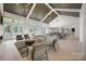 Bright lounge features high ceilings, modern lighting and comfortable seating near doors leading to the community pool at 1107 Meander Ln, Waxhaw, NC 28173