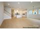 Spacious open floor plan featuring a staircase and a seamless transition to the all-white kitchen at 1107 Meander Ln, Waxhaw, NC 28173