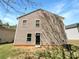 Back exterior of home features neutral siding, black door, with small area to side for AC unit at 1107 Stonehenge Ln, Charlotte, NC 28216