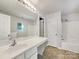 Clean bathroom featuring a large vanity with a sink, tub with shower, and modern fixtures at 1107 Stonehenge Ln, Charlotte, NC 28216