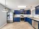 Bright kitchen featuring stainless steel appliances, dark cabinets, and wood-look flooring at 1107 Stonehenge Ln, Charlotte, NC 28216