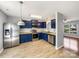 Bright kitchen featuring stainless steel appliances, dark cabinets, and wood-look flooring at 1107 Stonehenge Ln, Charlotte, NC 28216