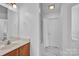 Bathroom with wood vanity, white walls, and sleek marble floors at 126 Newsome Rd, Salisbury, NC 28146