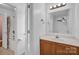 Bathroom with a wood vanity and a tub and shower combination with white fixtures at 126 Newsome Rd, Salisbury, NC 28146