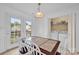 Bright dining area with backyard access, dining table, and convenient laundry room at 126 Newsome Rd, Salisbury, NC 28146