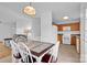 Inviting dining area featuring a table set for six, complemented by natural light and an adjacent living space at 126 Newsome Rd, Salisbury, NC 28146