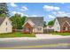 Street view of a cozy home with a brick and siding exterior, neat landscaping, and a driveway at 126 Newsome Rd, Salisbury, NC 28146
