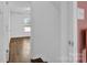 Hallway with wood flooring, white walls and natural light from window at end of hall at 126 Newsome Rd, Salisbury, NC 28146