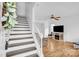 Bright living room with wood floors, a ceiling fan, and staircase leading to the upper level at 126 Newsome Rd, Salisbury, NC 28146