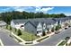 New construction townhomes displaying modern exteriors, landscaped yards, and a serene community setting at 134 Berkeley Ave, Mooresville, NC 28117